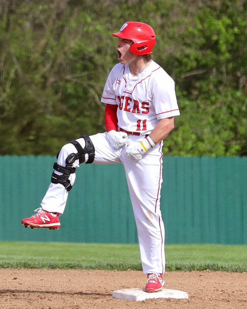 An Ozark High School baseball player celebrates after hitting a double in a game against Carl Junction High School in Ozark, Missouri.