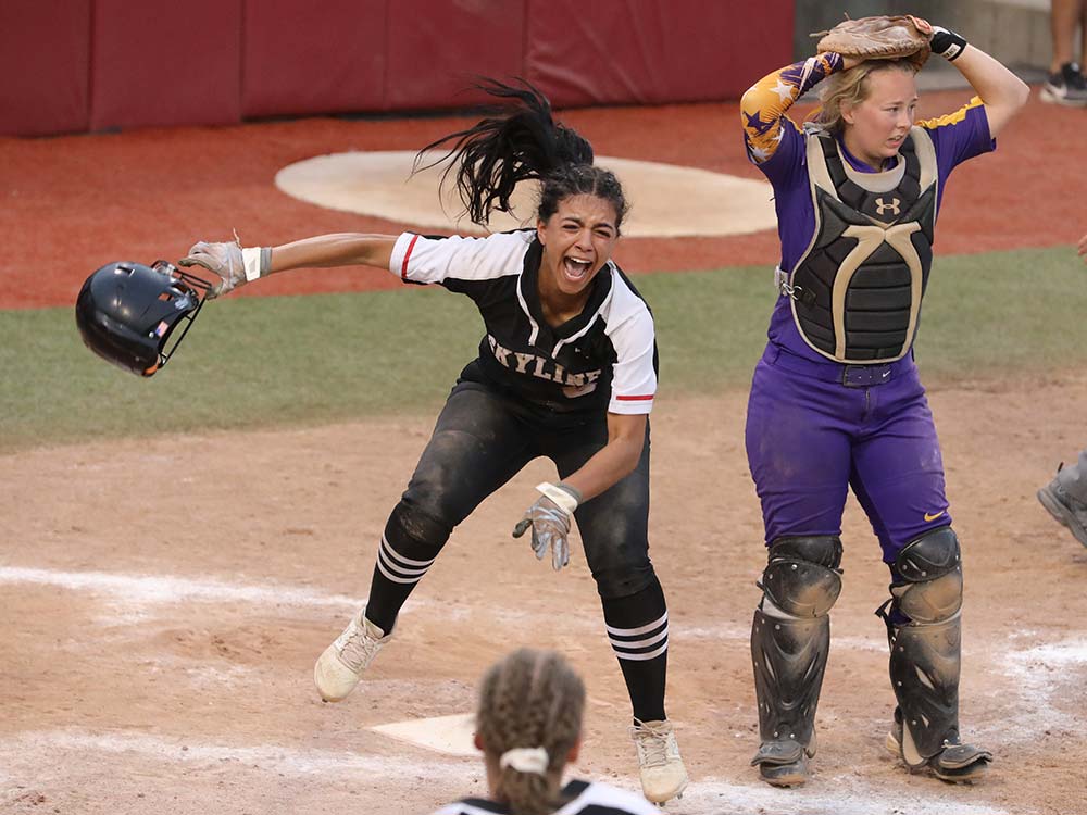 Skyline's Keelie Holmes celebrates after scoring the winning run in the Class 2 state softball championship game on May 23, 2021.