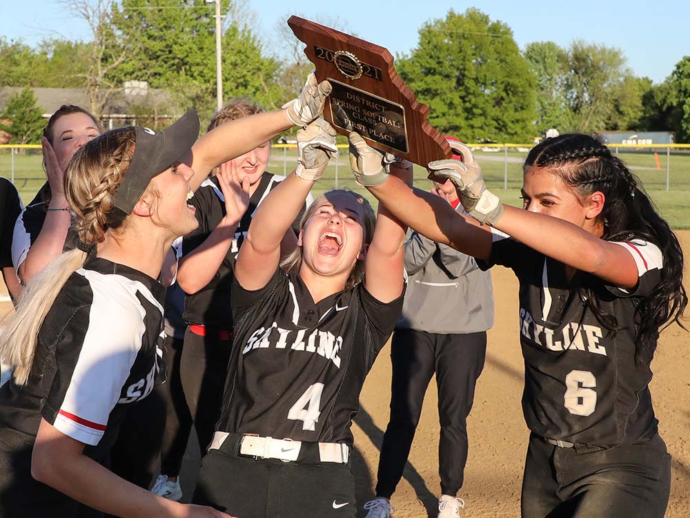 Skyline softball players celebrate after beating Strafford to win the school's first district championship since 2002.