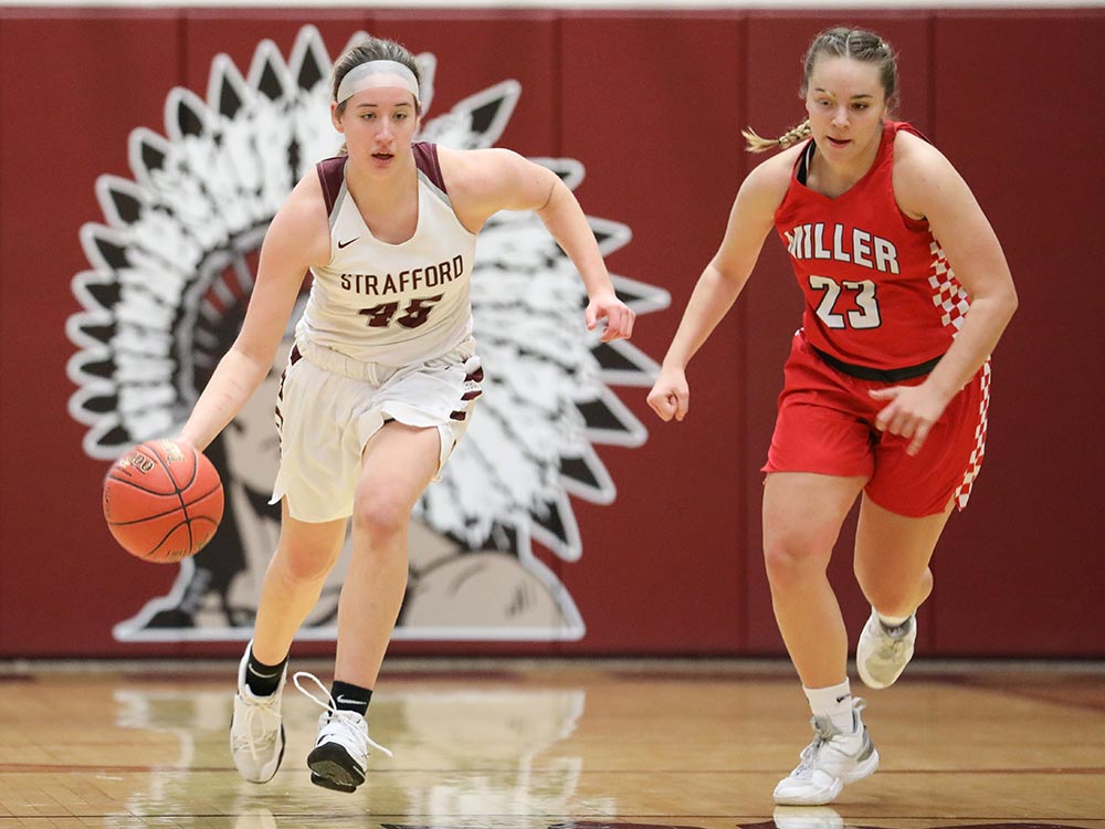 Players from Miller and Strafford compete in a high school basketball game on January 8, 2021.