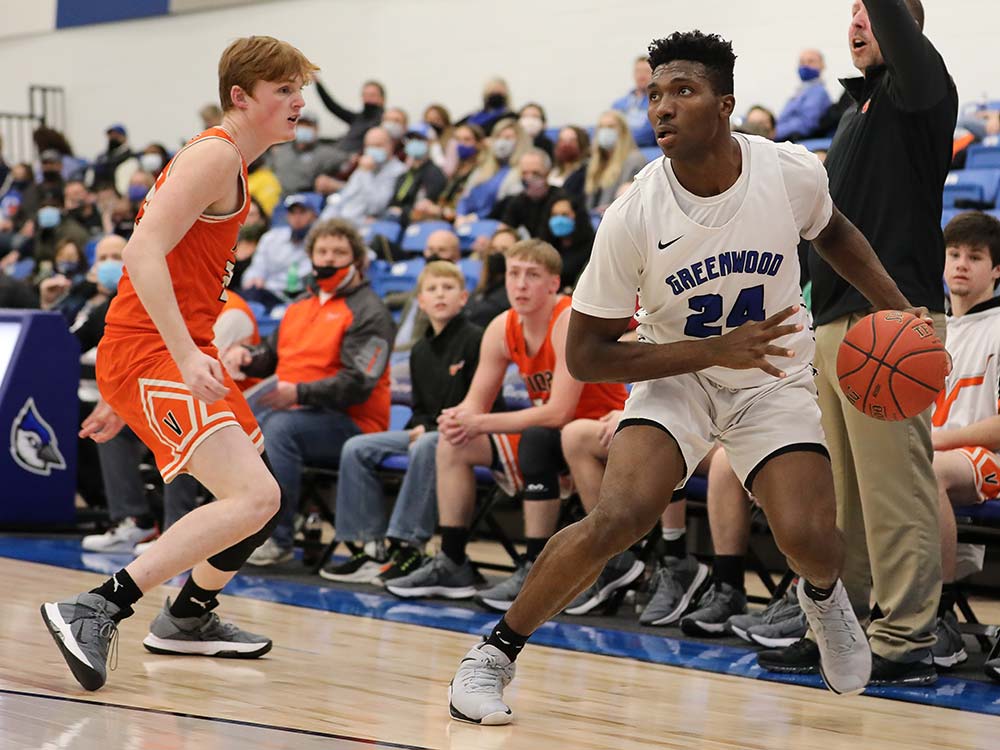 Greenwood's Aminu Mohammed dribbles against a Viola defender during a high school basketball game on January 21, 2021, in Springfield, Missouri.