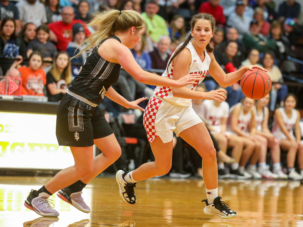 Miller and Walnut Grove compete in a high school basketball game on December 30, 2021, in Walnut Grove, Missouri.