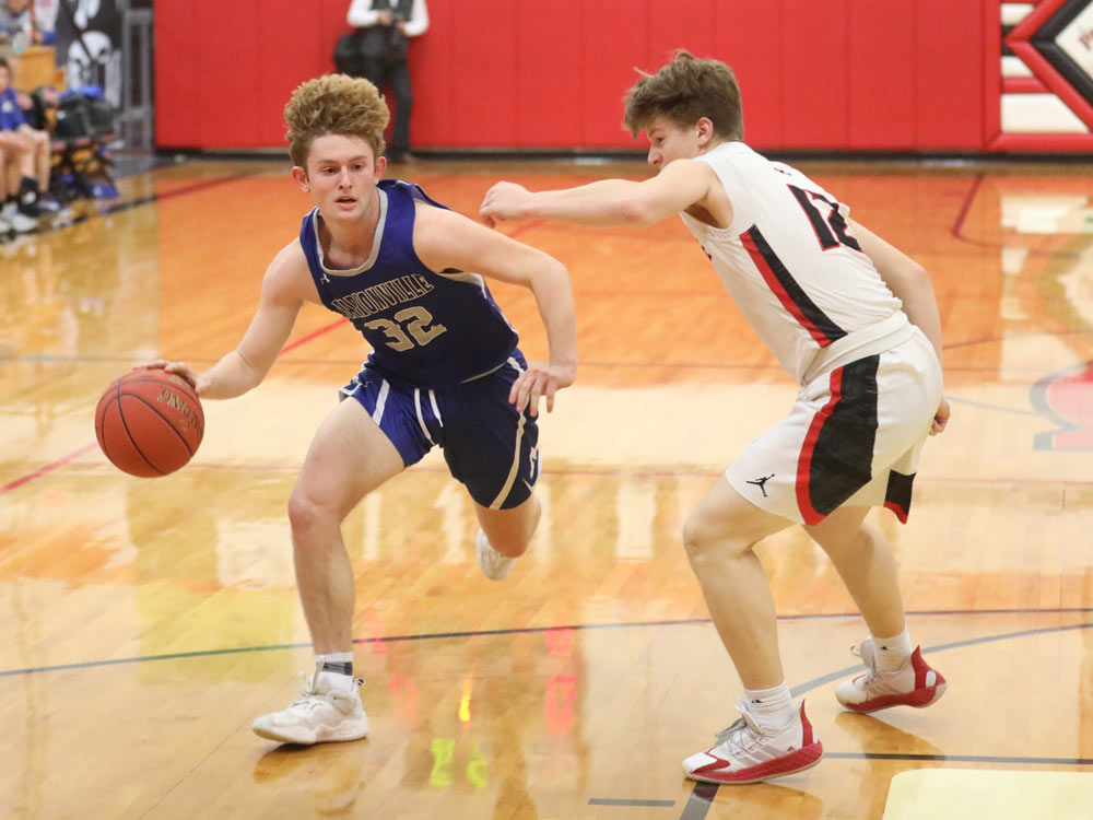 Players from Ash Grove and Marionville compete in a high school basketball game on February 8, 2022, in Ash Grove, Missouri
